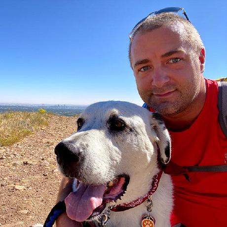 Me posing with my dog on a hiking trail